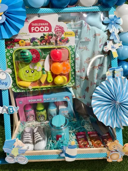 Another angle of the birthday hamper, showing the polka-dotted frame and paper fans.