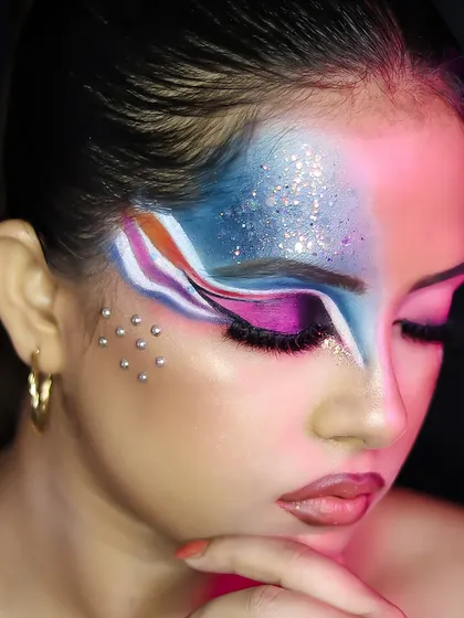 An abstract, colorful makeup look with graphic lines and glitter, showcasing pure artistic expression.