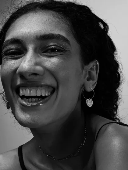 There is nothing more beautiful than a genuine, uninhibited smile. This black and white close-up captures pure joy, proving that the most powerful portraits are often the most candid.