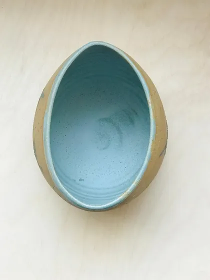 A top-down view of the "Midnight Mischief" bowl, revealing the smooth, teal-glazed interior.