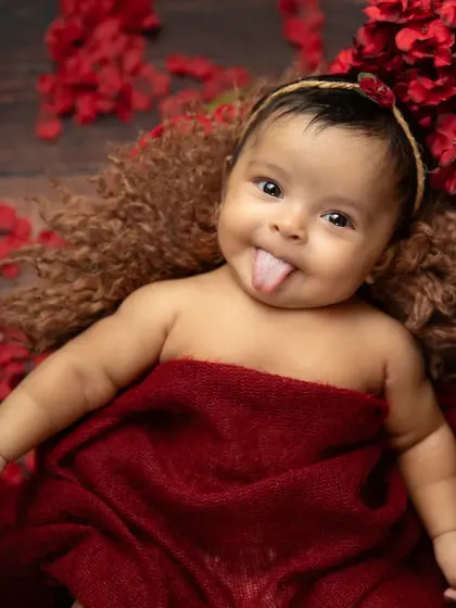 A playful and cheeky moment! It's always a treat when a baby shows off their personality with a little tongue-out expression during a shoot.