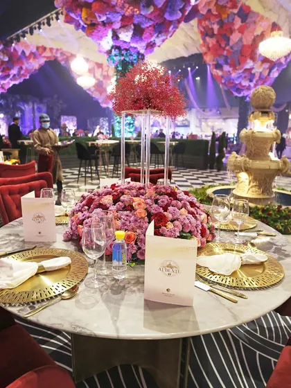 A beautifully arranged table at a high-end corporate event, featuring our custom menus and golden cutlery. Every element is chosen to reflect a standard of uncompromising quality and elegance.