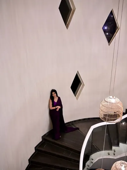 A wide shot showing the full spiral staircase, emphasizing the dramatic and architectural nature of the shoot.