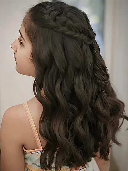 Slaying every strand. This intricate braided half-updo is perfect for a special occasion, combining beautiful braids with soft waves.