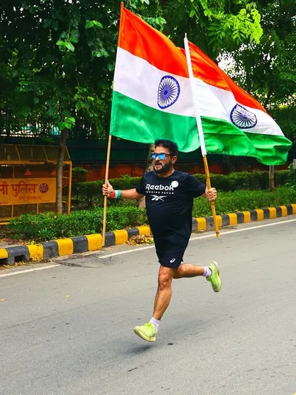 Here I am, leading the charge with two flags. My goal is to inspire everyone to run with heart and passion.