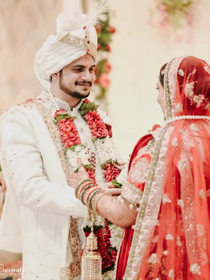 A candid shot of the groom's happy expression as he looks at his bride during the wedding ceremony.
