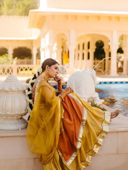 A side profile of Shree's Haldi look, showing her braided hairstyle adorned with fresh mogra flowers, a nod to South Indian tradition.