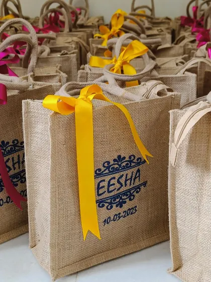 A detailed shot of the custom printing on the jute bag, featuring the bride's name and wedding date.