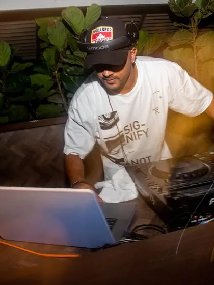 A long-exposure shot capturing the motion and energy at the DJ console. This is what it looks like when the beats are dropping.
