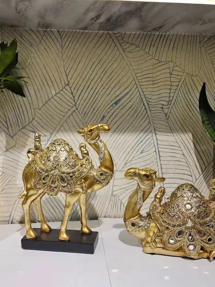 Our decorative mirror-work camel pair in a regal gold finish. These pieces bring a touch of royal Rajasthani elegance to your home.
