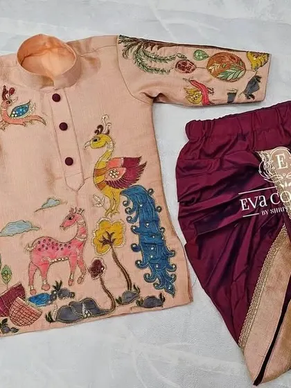 My designs for boys are just as special. This custom Kalamkari kurta features hand-painted nature motifs, paired with a comfortable and stylish maroon dhoti.