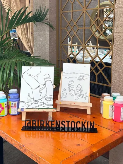 A close-up of the custom Birkenstock-themed canvases. We can create designs to match any brand or event theme.