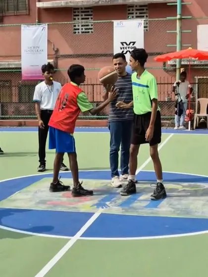 Mr. Darshan kicks off a match with a jump ball at the Hi 5 Youth Foundation's basketball league. These moments of collaboration bring energy and encouragement to the young players.