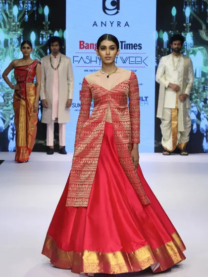 The full ensemble on the runway, showing how the Banarasi koti and silk skirt create a grand, layered silhouette. This is a regal and innovative way to wear traditional textiles.