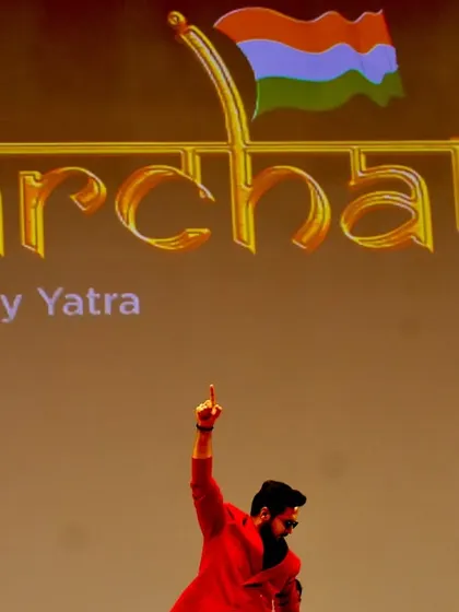 A powerful moment on stage during the 'Parcham' tour. This shot captures the feeling of leading a 'Vijay Yatra' (Victory March) for thousands of aspiring students.
