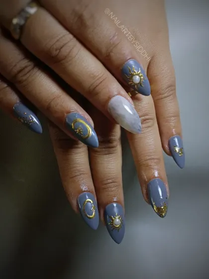 A full hand view of the celestial sun and moon nail art, showing the complete design.