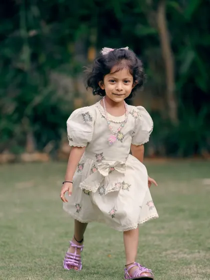 A similar frame showing the young girl's joyful expression as she explores the outdoors during her family's photo session.