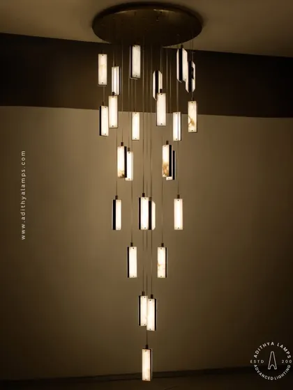 These modern pendants feature a unique combination of translucent marble and stitched leather accents. The warm light glows through the marble, creating a sophisticated and texturally rich fixture for contemporary spaces.