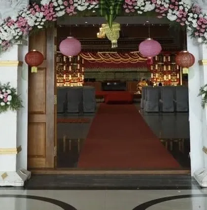 The entrance to a wedding hall we decorated. We created a grand floral arch and used hanging lanterns to welcome guests into the beautifully decorated reception area.