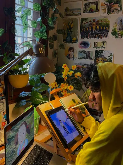Me in my happy place, working on a digital painting. Surrounded by my art and plants, this is where I feel most creative and at peace.