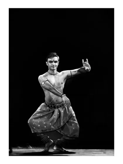 A black and white photograph of a solo pose, emphasizing the form and expression of the dance without the distraction of color.