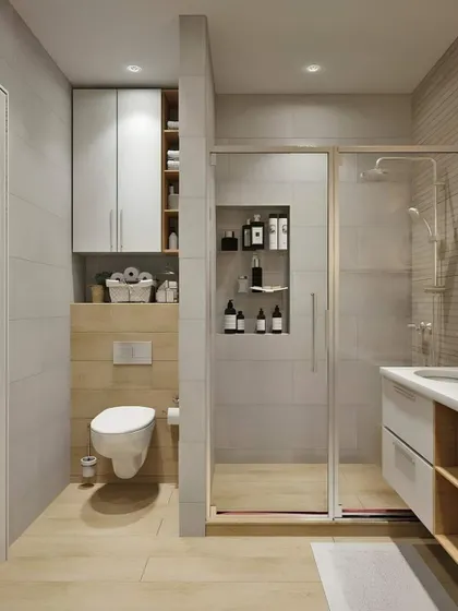 A compact bathroom design that cleverly uses vertical space. The wall-mounted toilet allows for easy cleaning, while the built-in shelving above and in the shower provides ample storage.