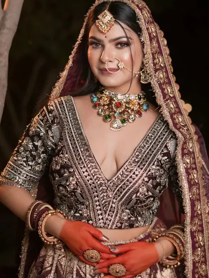 A close-up of the intricately embroidered blouse, paired with a multi-color navratna choker.