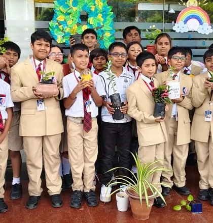 Middle school students proudly hold up saplings during our World Environment Day celebration, ready to contribute to our campus greening efforts.