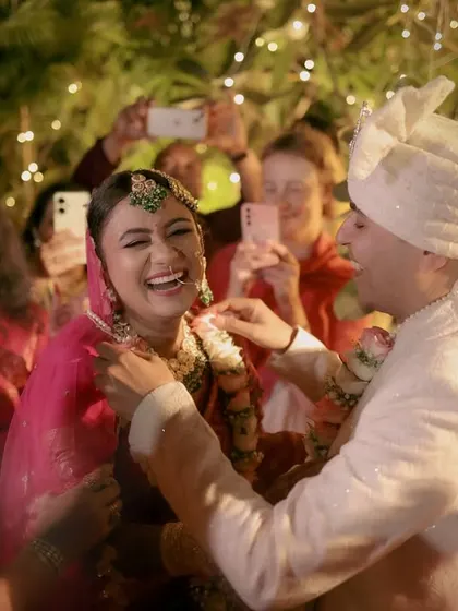 Pure, unadulterated joy as the couple celebrates their marriage, surrounded by clapping friends and family.