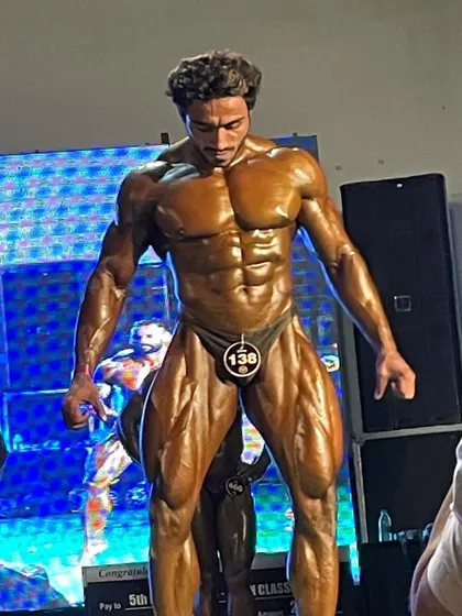 A competitor posing on stage, showing great conditioning.