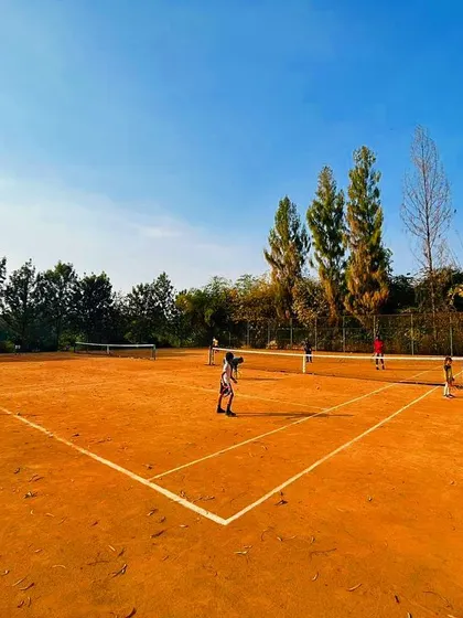 A glimpse of daily life at our serene Yelahanka facility. Our well maintained clay courts provide the perfect training ground for players to hone their skills, surrounded by nature and focused on the game.