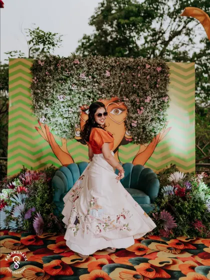 The bride twirling in front of a quirky and colorful mural at her carnival-themed party.