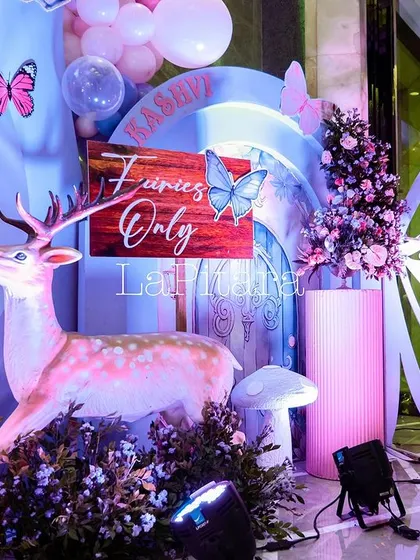 A whimsical decor detail with a deer prop and a sign that reads 'Fairies Only'.