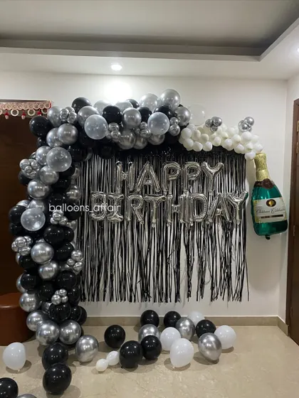 This angle shows the depth of the balloon arch and how it frames the "Happy Birthday" message perfectly for photos.