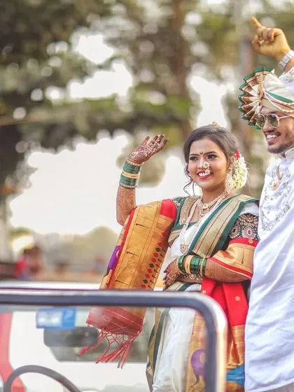 The grand exit. A fun shot of the newly married couple waving from their wedding vehicle, ready to start their new life together.