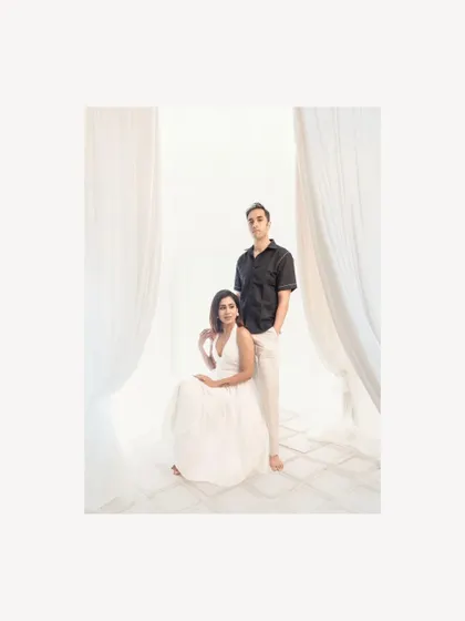 A poised and elegant couple portrait taken in the studio. The soft lighting and clean background create a feeling of modern romance and quiet connection.