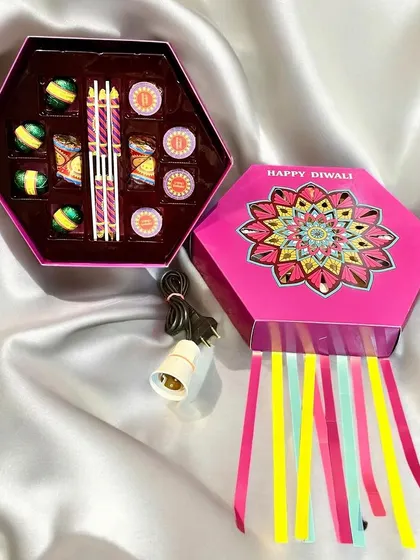 This unique Diwali gift box is designed to look like a festive lantern. It opens to reveal a collection of chocolates and includes a light fixture to turn the box into a functional piece of decor.