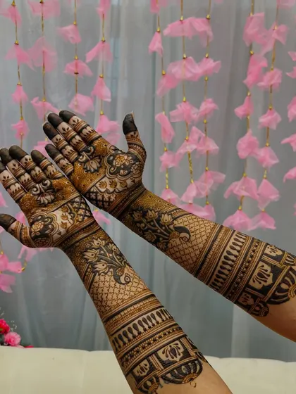 This engagement design features elegant peacocks and floral patterns that flow up the arms. The use of both fine lines and bold-filled areas creates a beautiful contrast.