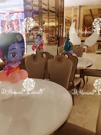 A cute Little Krishna character on a balloon base makes for a perfect table centerpiece, tying the whole theme together.