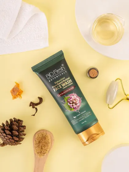 A styled flat lay of Biofresh Botanicals' face wash with skincare tools and natural elements. This top-down view shows the product as part of a complete self-care ritual.