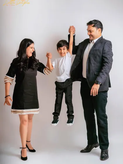 Pure fun! Swinging their son between them, this pose is full of movement and joy, perfect for capturing a family's playful side.