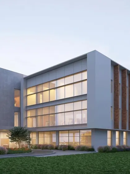 The exterior of the JSW Nagaur administrative building, showing the use of brick fins for solar shading. This passive design strategy is essential for creating an energy-efficient building in Rajasthan's climate.
