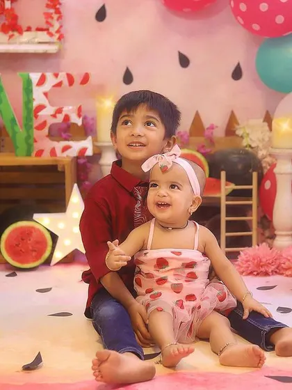 Big brother and little sister sharing a sweet moment. Sibling photos are a wonderful way to celebrate the family bond.