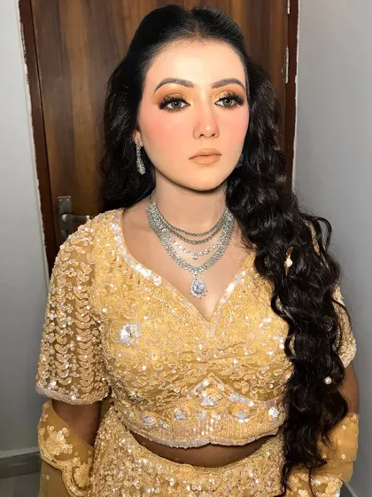 A close-up of the golden engagement makeup look.