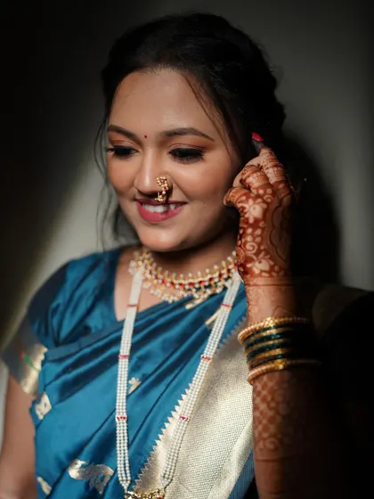 A close-up of Shivali's engagement look. You can see the detail in the soft eye makeup and the traditional 'naath', which adds a classic Maharashtrian touch.
