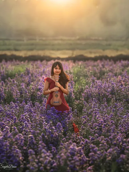 The magic of photography extends beyond the studio walls. This portrait, set in a field of lavender flowers under a golden sun, captures a sense of dreamlike wonder. It shows how we can use nature's canvas to create a whimsical and beautiful storybook moment.