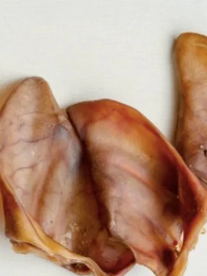 A simple, close-up view of my Dehydrated Pork Ears. You can see the natural texture because they are simply air-dried with no added junk. Just pure, protein-packed goodness for your pup.