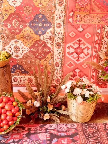Details from the Souk Bazaar theme, including fresh produce in wicker baskets and rustic floral arrangements set against a backdrop of patterned carpets. It's the small details that bring a theme to life.