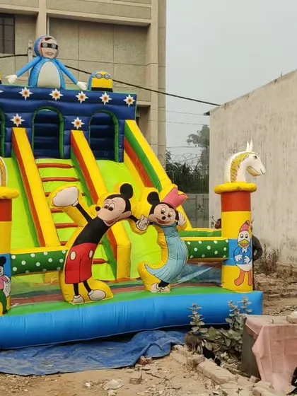 A dual-slide bouncy castle with horse figures and a Mickey Mouse theme. This shows how we can combine different elements into one design.