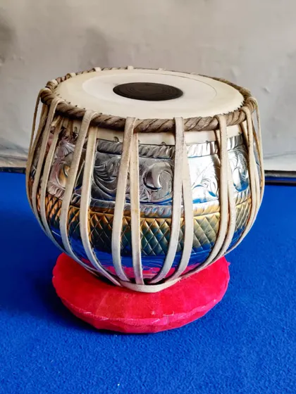 A close-up of a delivered 3kg pittal baya (left-hand drum). This designer piece features intricate chrome and brass work, combining beautiful aesthetics with professional sound quality.